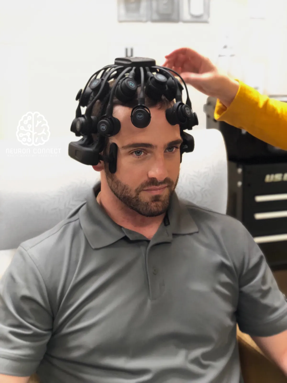 Clinician fitting the Freedom 20R headset on a concussion patient